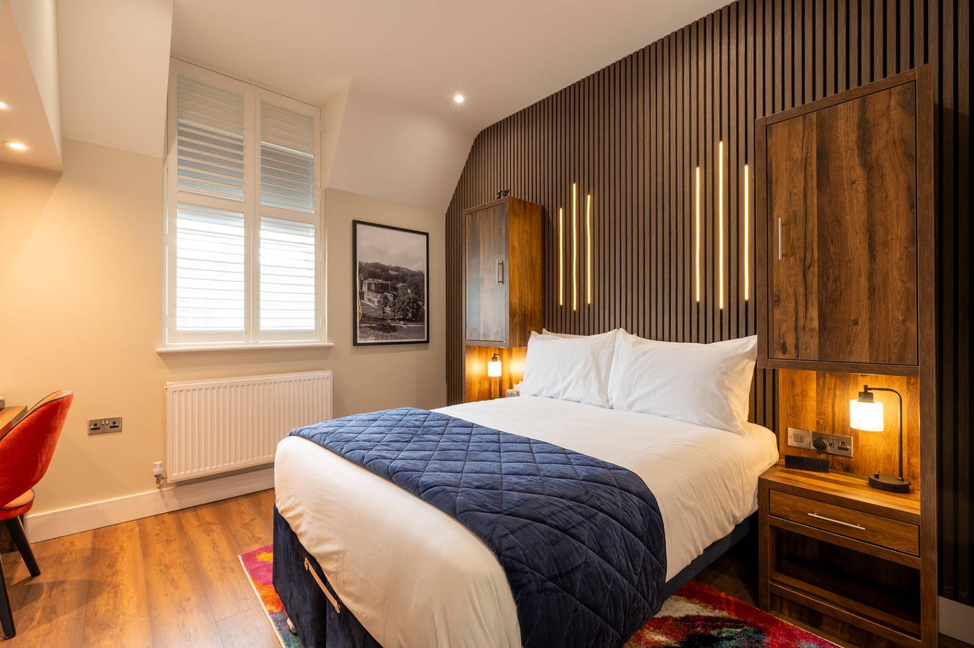 View of a bedroom with an open door leading to the rest of an apartment in The Old Brewery, Barrow-in-Furness