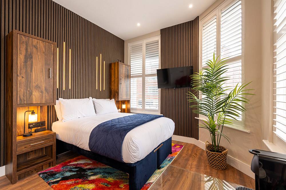 Sofa, coffee table, chairs and kitchen facilities in The Old Brewery, Barrow-in-Furness